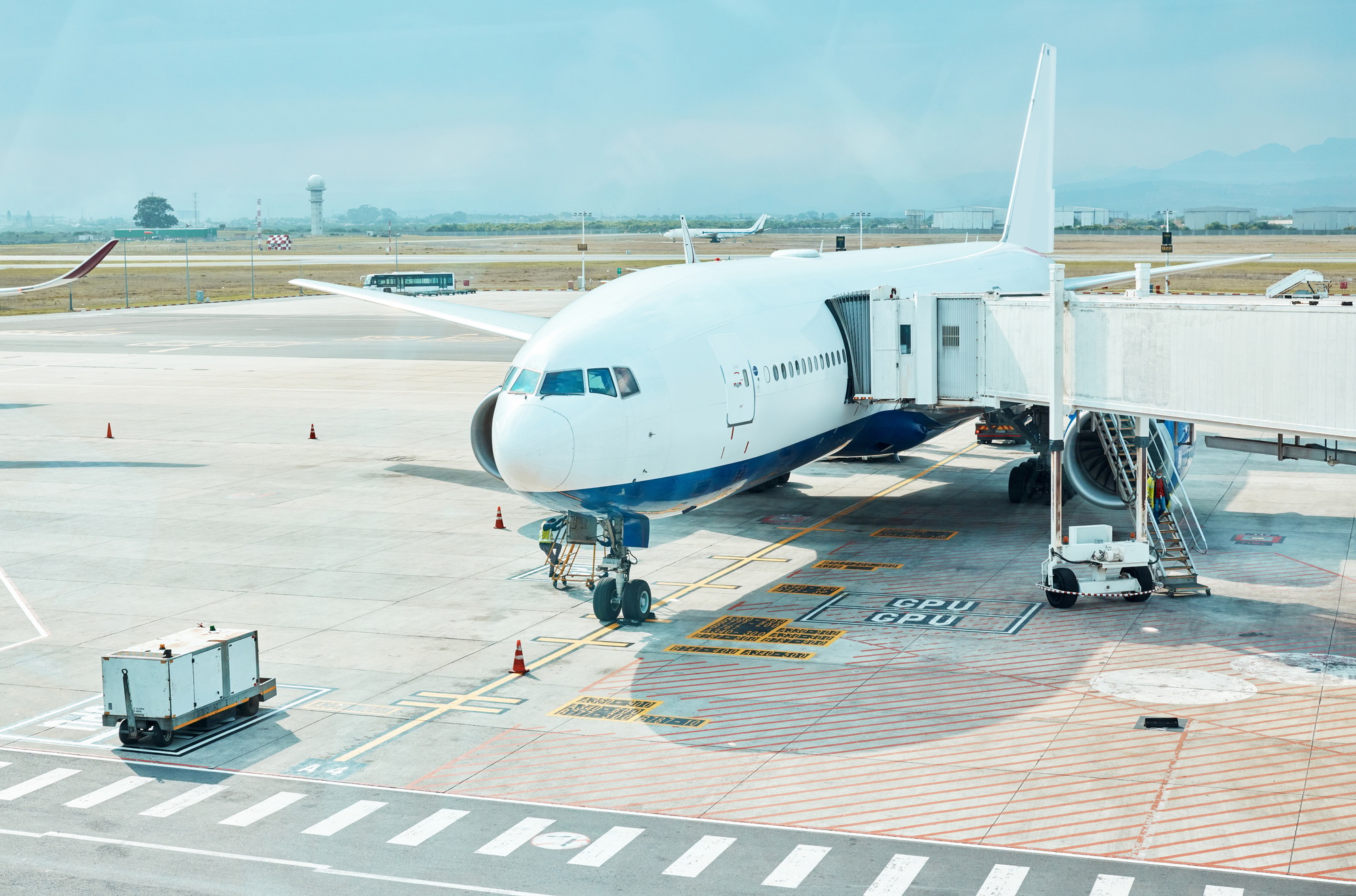 Airplane, airport and runway near terminal and boarding steps for a flight for travel, logistics or